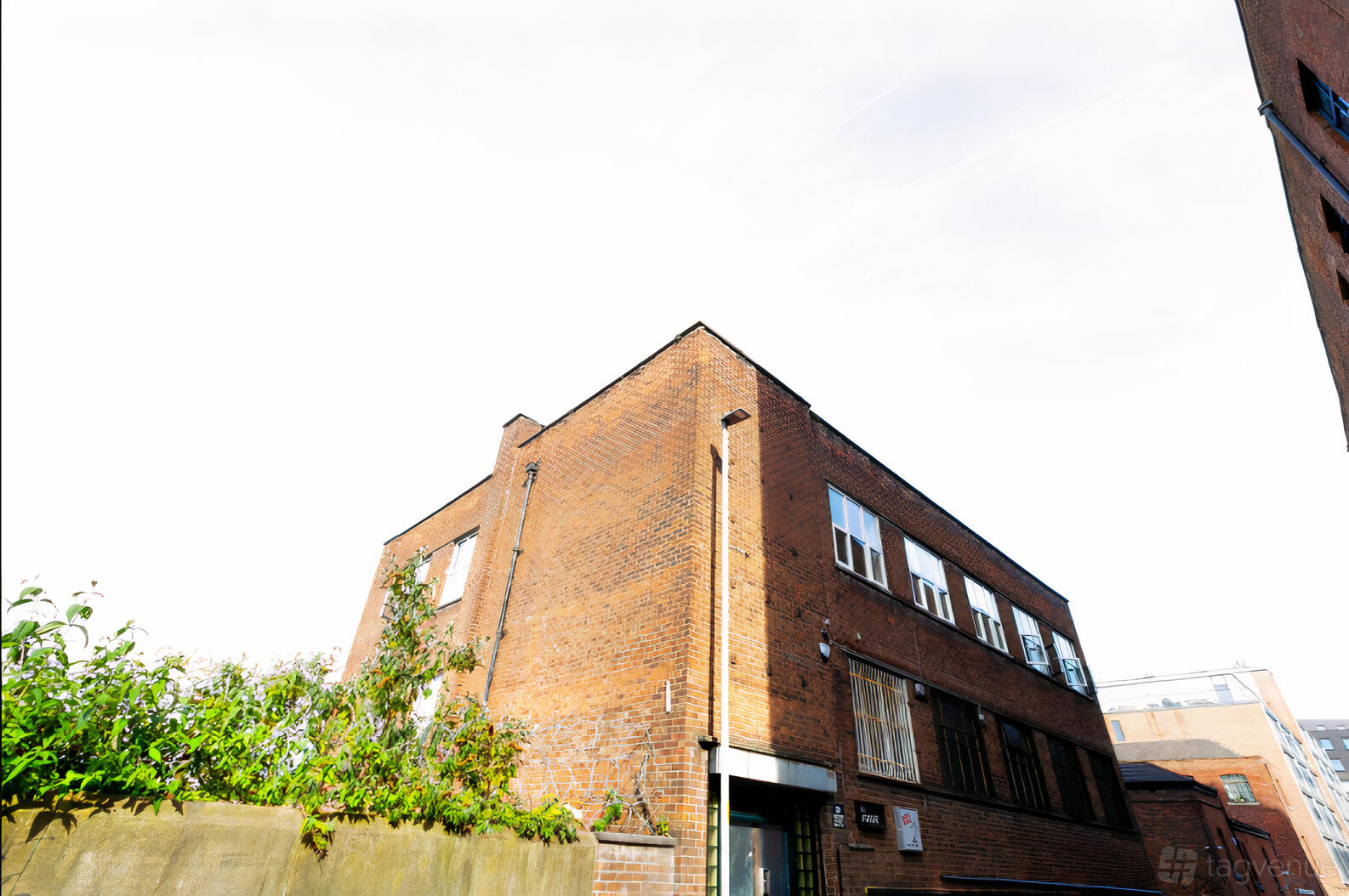 A film and photo studio with a brick exterior and large windows at Spectrum Studios.