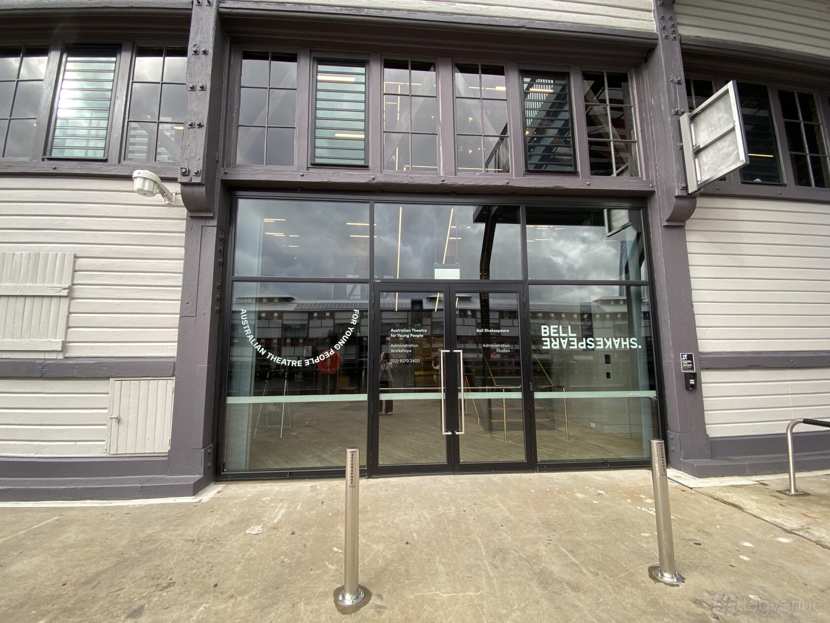 A theatre entrance with large glass doors and visible seating inside at Australian Theatre for Young People.