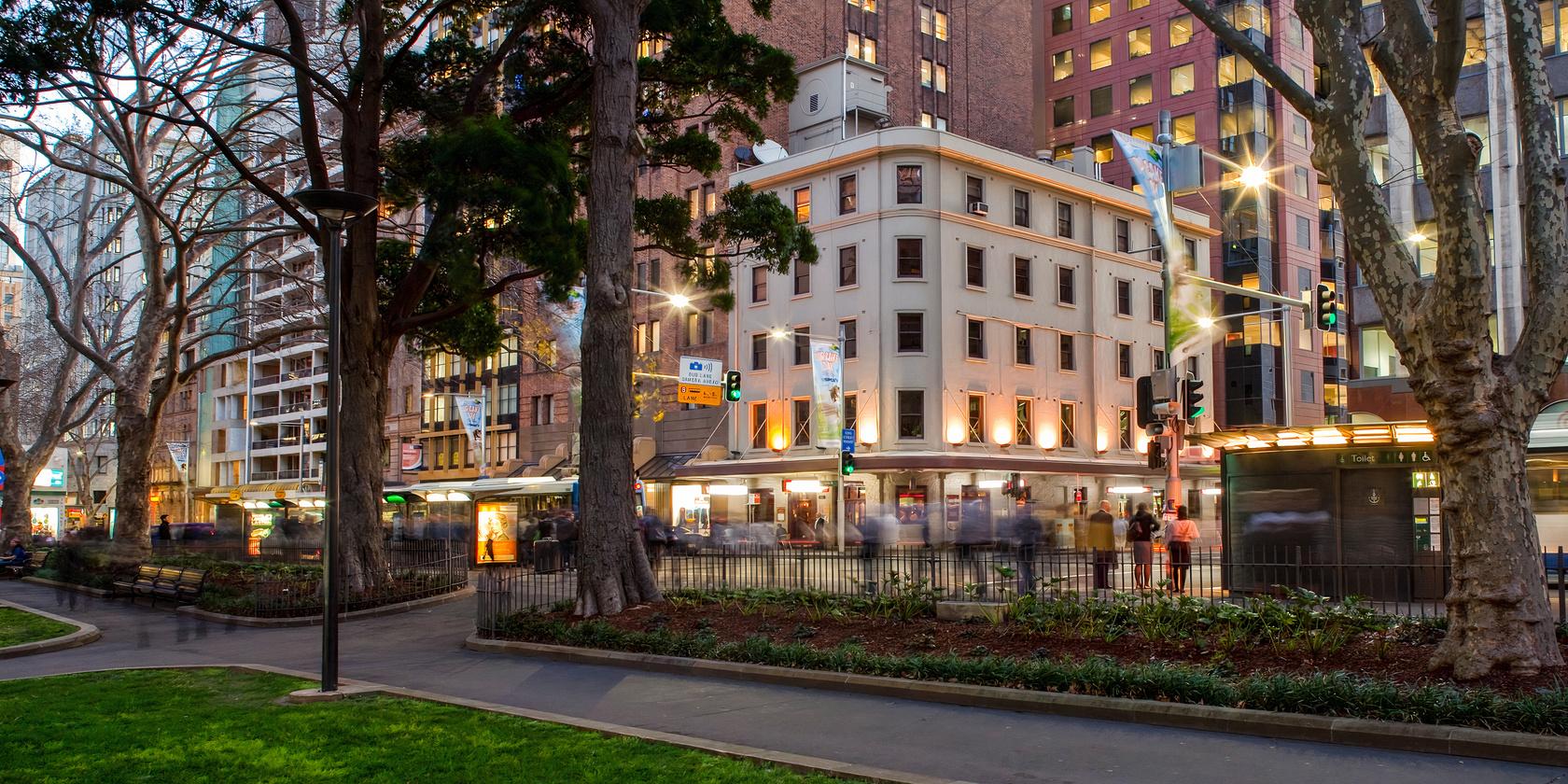 A hotel with a multi-story white facade, large corner windows, and city views at The Occidental.