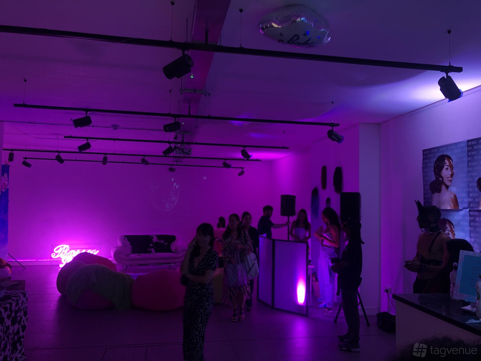 A gallery function room with purple ambient lighting, neon signage, and contemporary wall art at The Old Street Gallery.