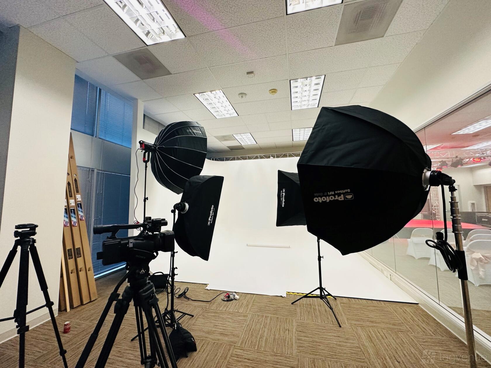 An event venue featuring a white cyclorama wall, softbox lighting, and cameras set up at CHTV Media & Entertainment LLC.