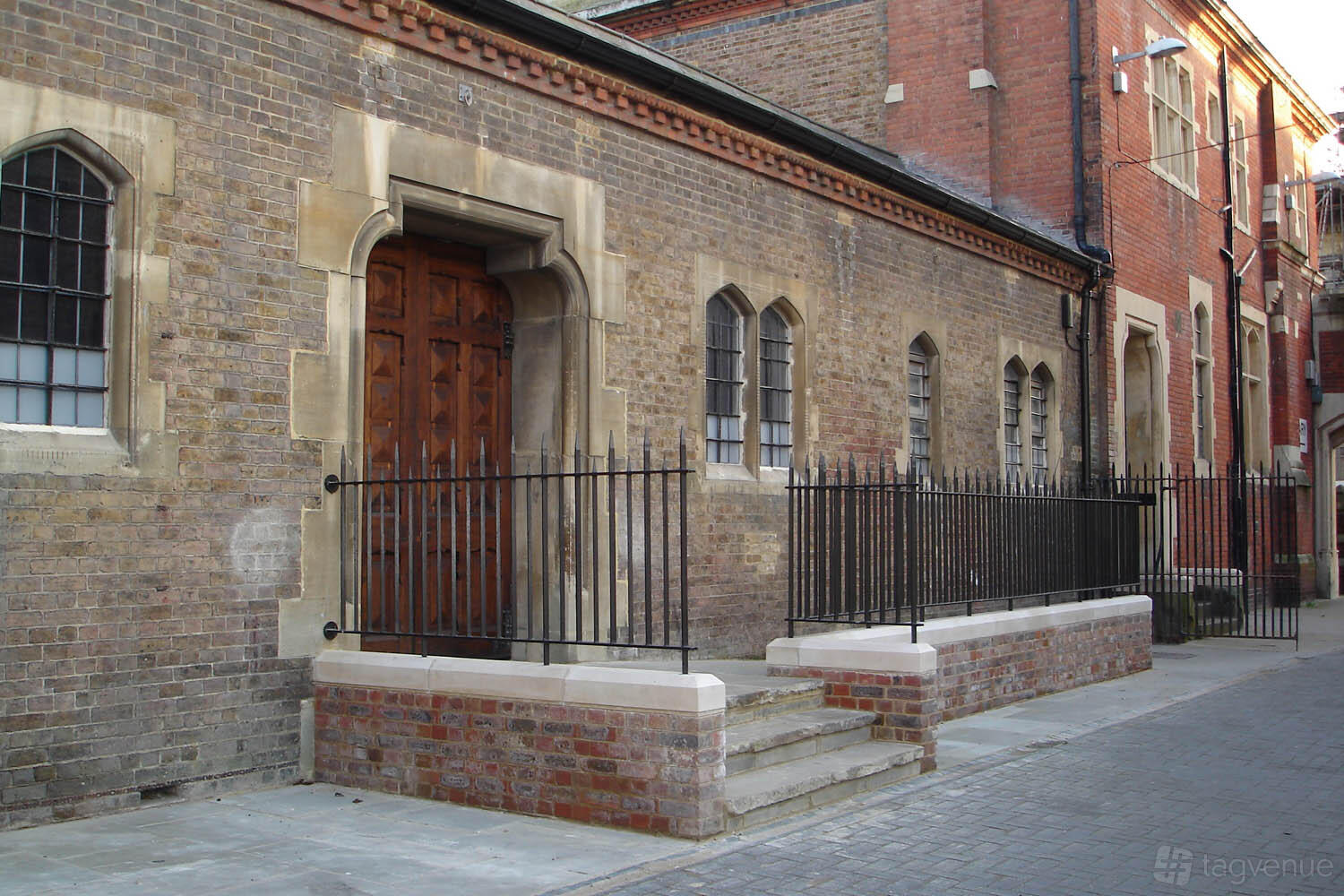 A historic event venue with arched windows, brick exterior, and wooden doors at The Old Courthouse.