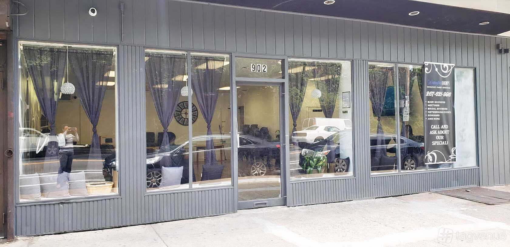 A versatile event space with floor-to-ceiling windows, sheer curtains, and potted plants at Washington's Events.