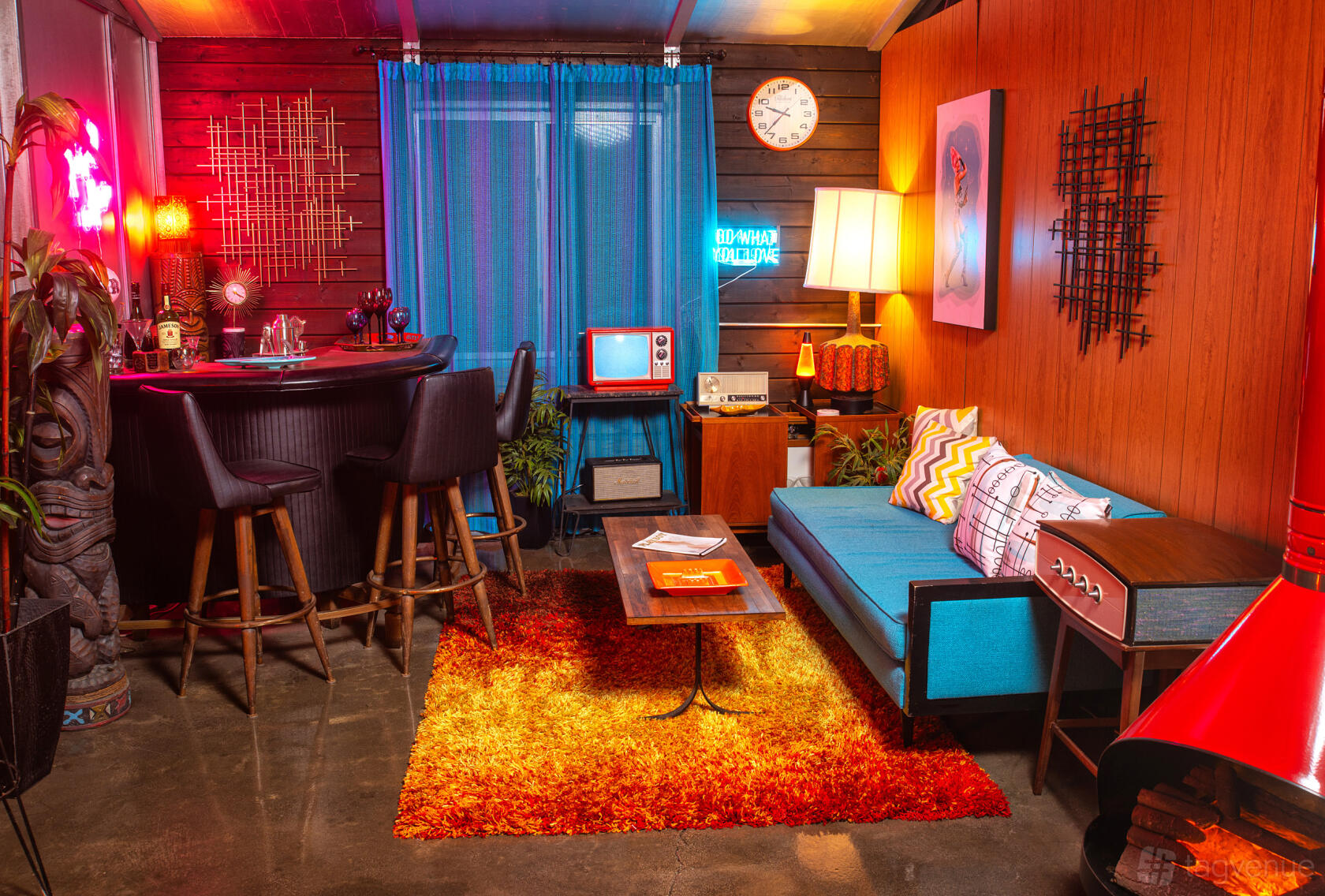 A photo studio with retro lounge furniture, colorful decor, and vintage bar setup at Fuze Studios.