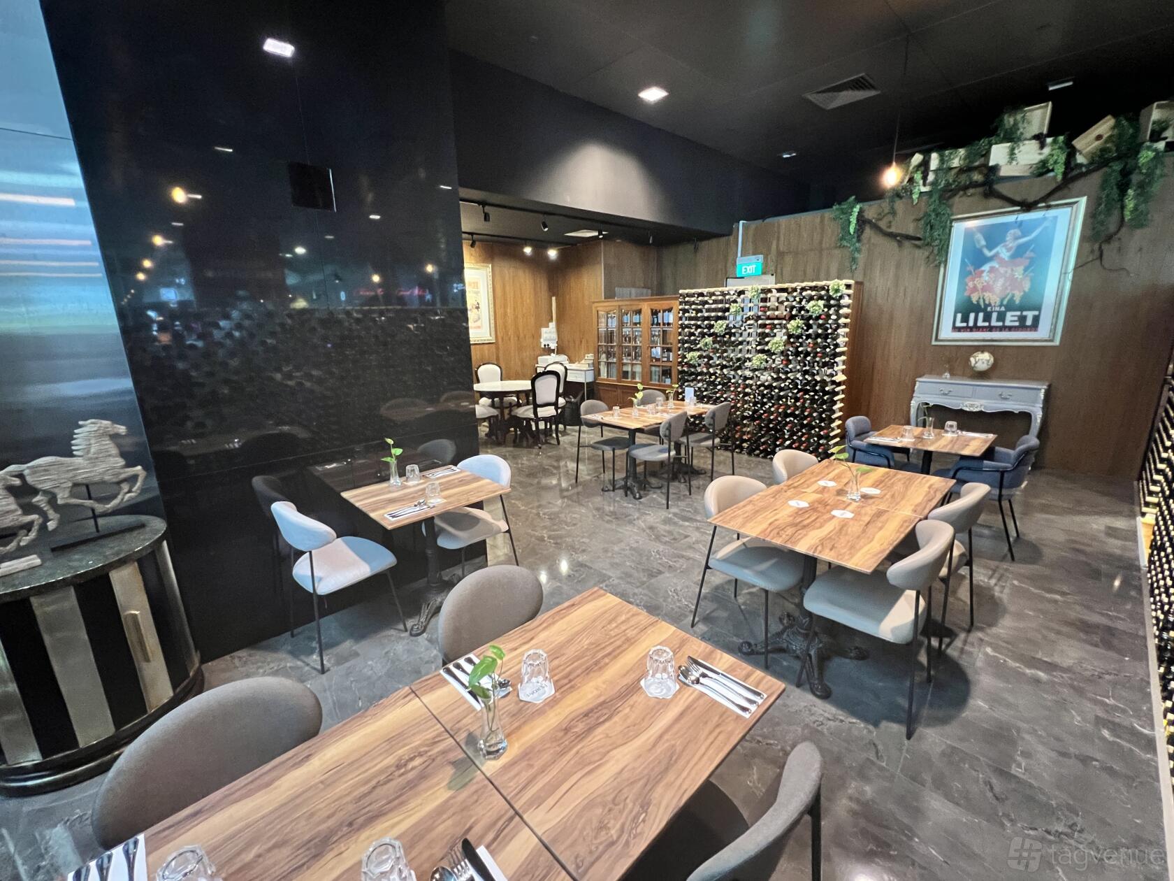 A dining room with wooden tables, upholstered chairs, and a wall-mounted wine rack at Boulevard at Asia Square.