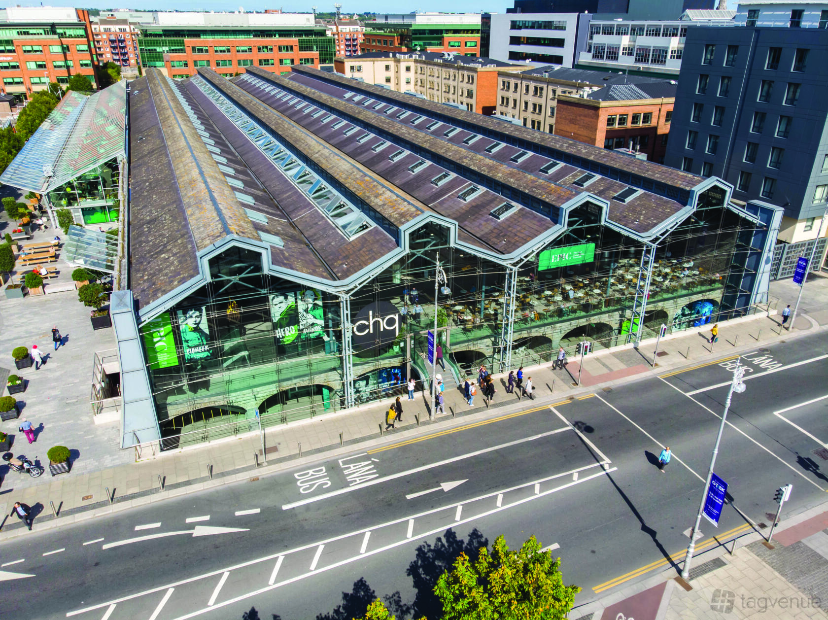 A glass-fronted event space with tall arched windows, pitched roof, and urban surroundings at EPIC & CHQ.