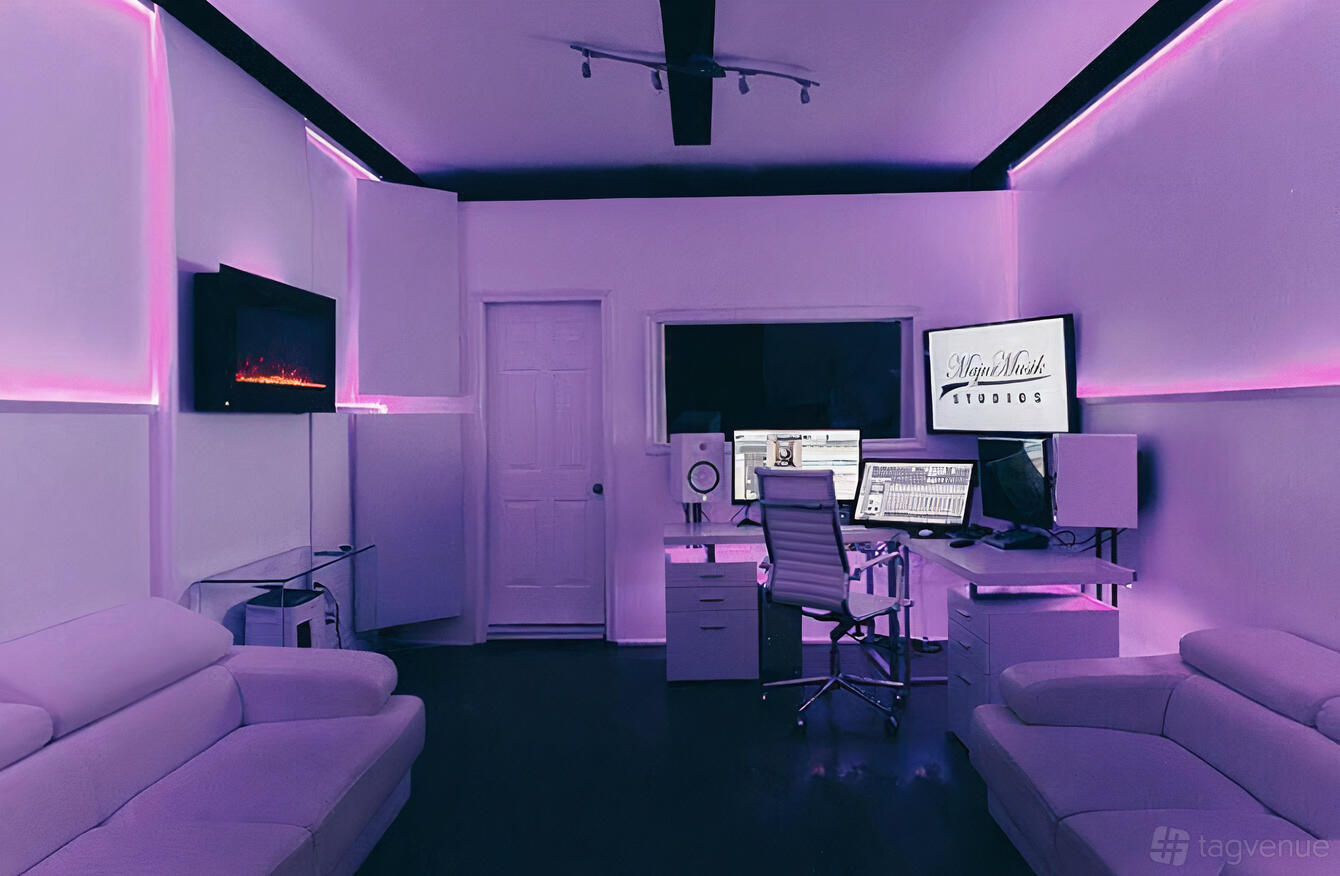 A music studio with LED accent lighting, soundproof walls, recording equipment, and white lounge seating at MajorMusik Crockford.