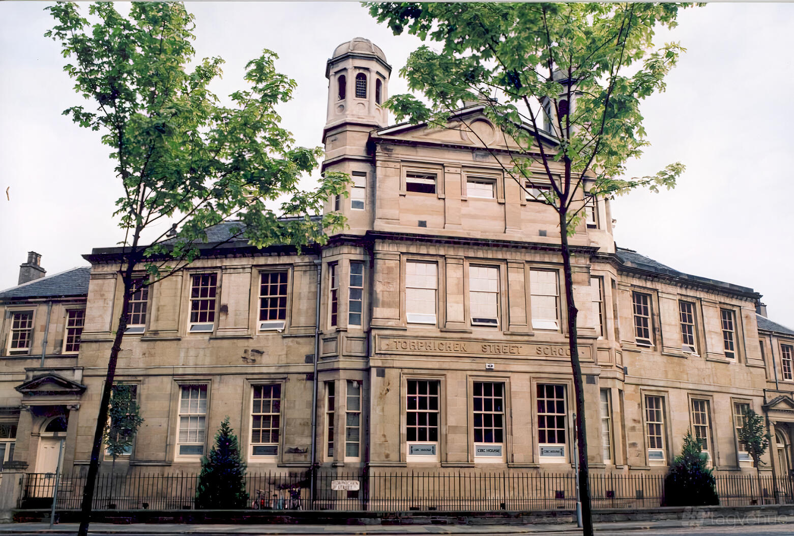 A historic meeting centre with stone facade, tall windows, and a domed tower at Capital Business Centre.