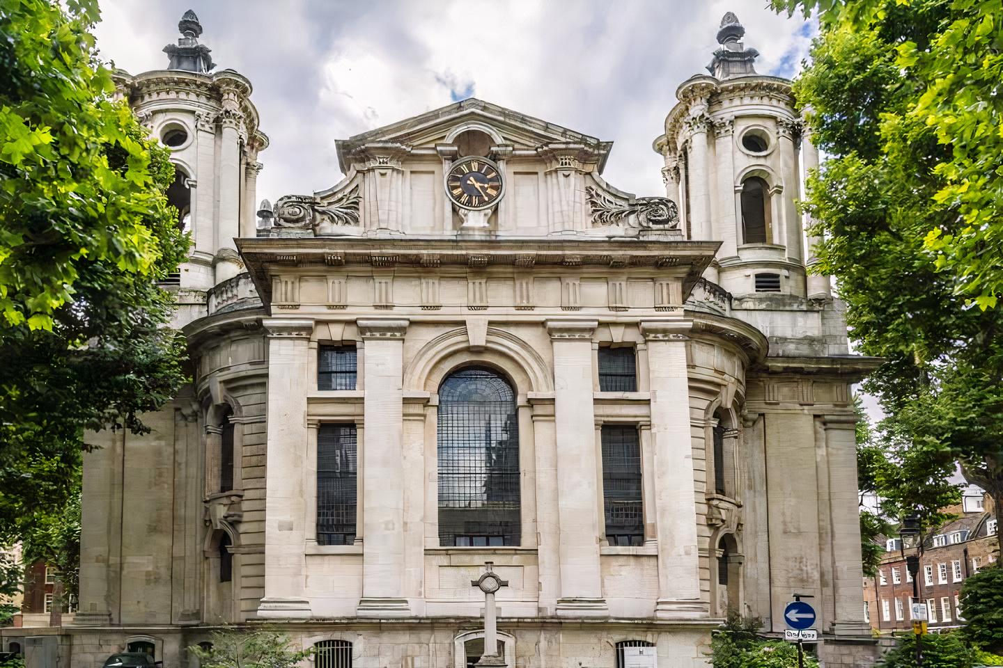 A historic building with grand columns, arched windows, and a central clock at Sinfonia Smith Square.