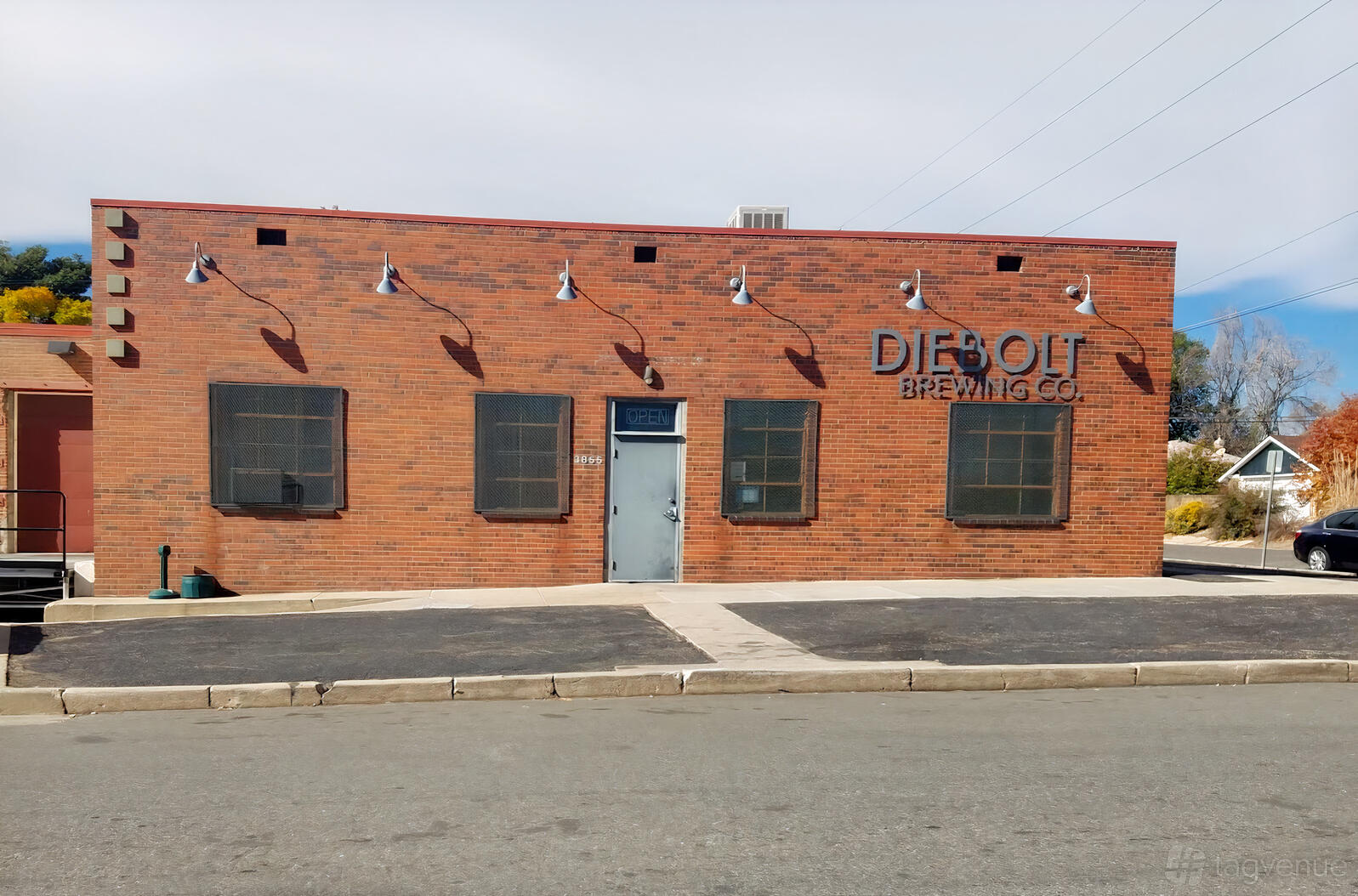 A brewery with brick exterior, industrial-style lights, and large windows at Diebolt Brewing Company.