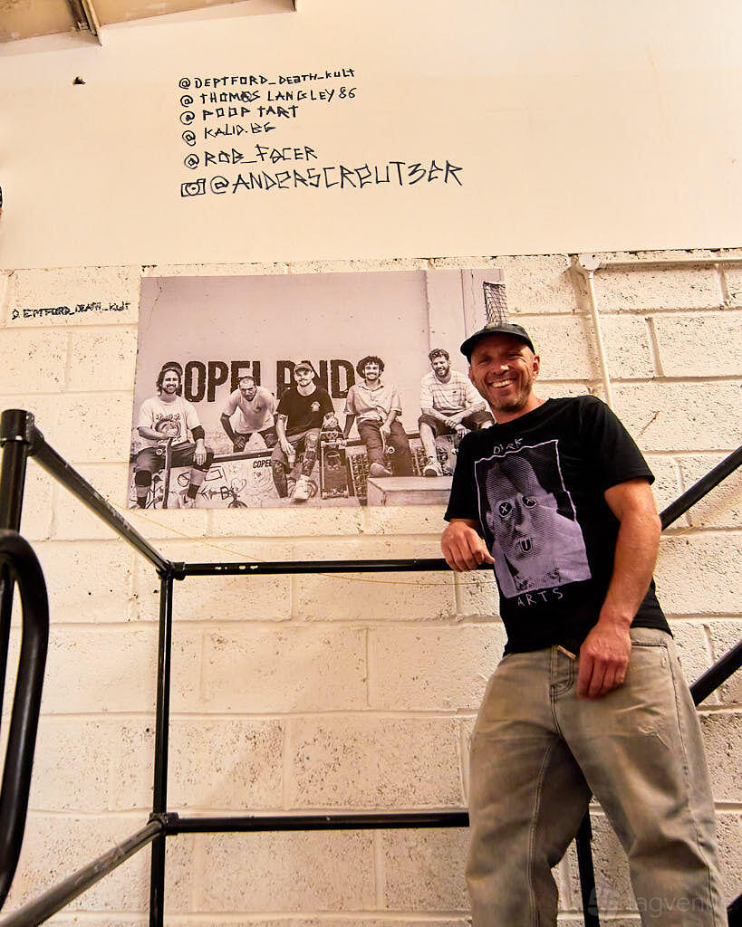 An event space in a school with a white brick wall and a large black-and-white group photo at School of Skate Copeland Park.