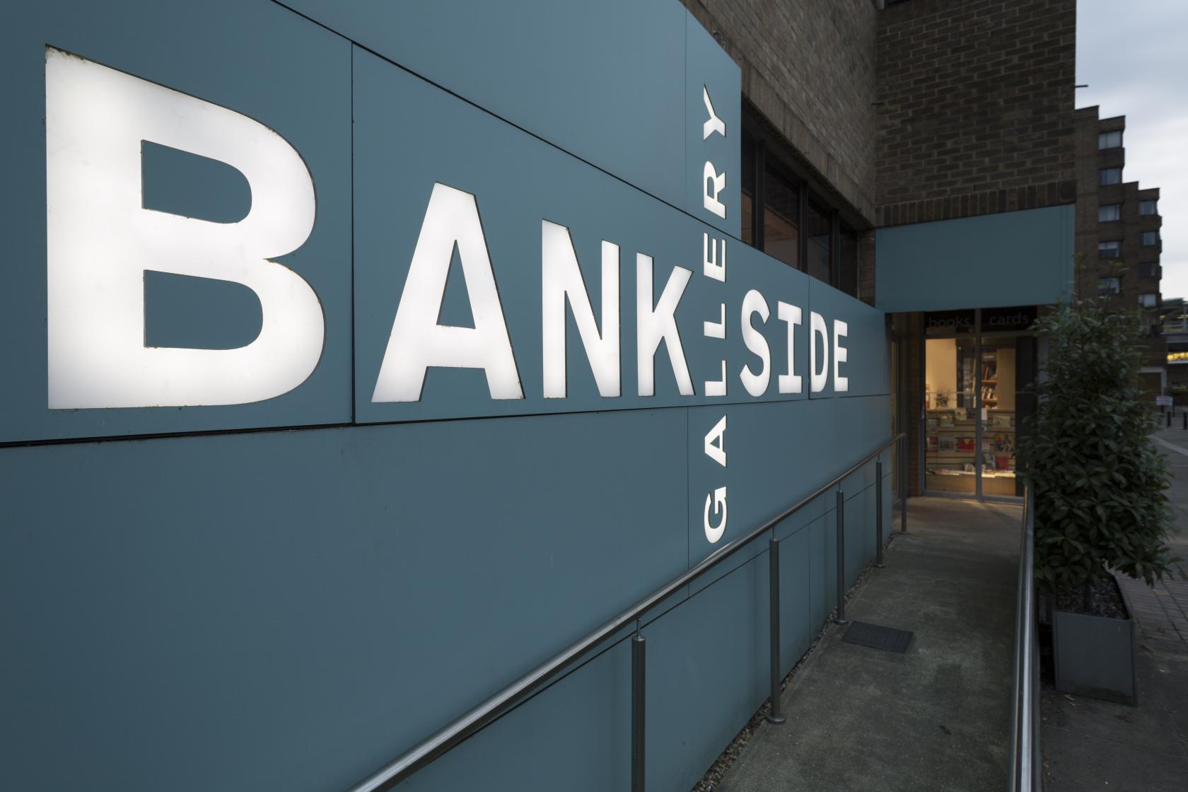An art gallery with a teal exterior sign displaying 'Bankside Gallery' beside the main entrance at Bankside Gallery.