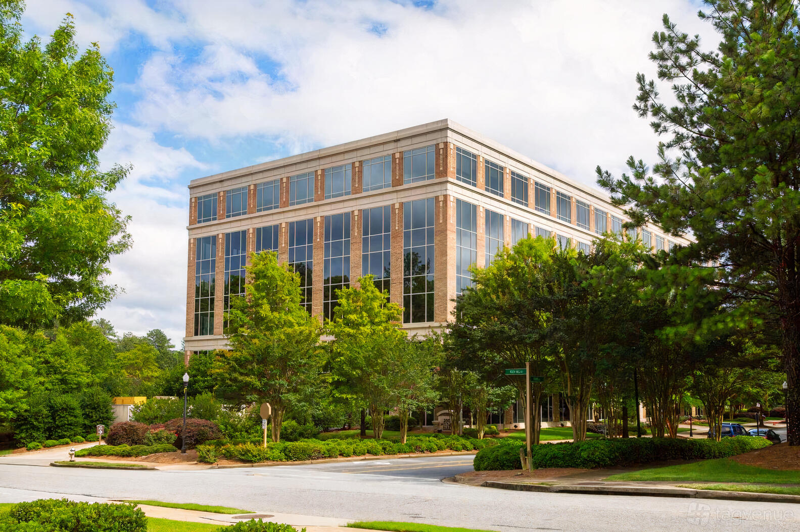 A meeting centre with a glass office building surrounded by trees at NorthPoint Executive Suites, Alpharetta.