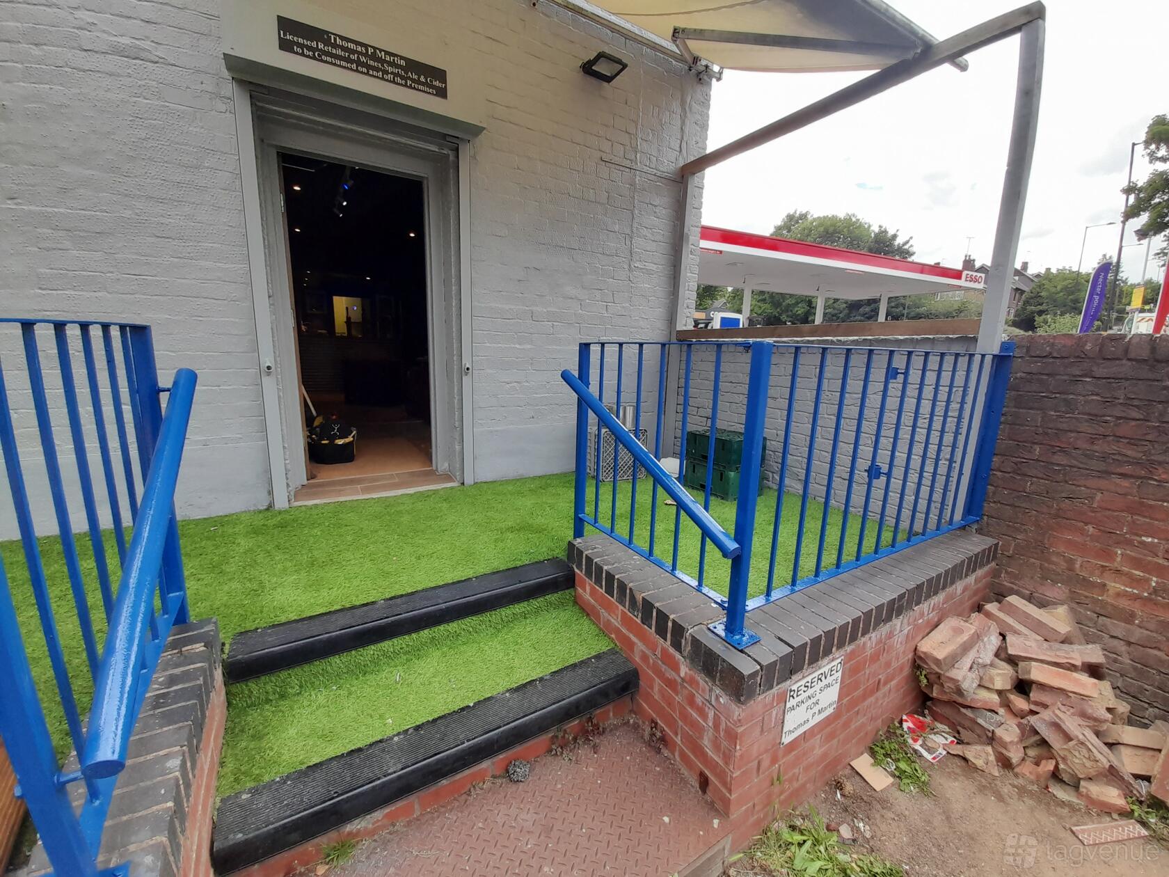 A versatile event space with artificial grass entry, blue railings, and brick steps at The Tower of Song.