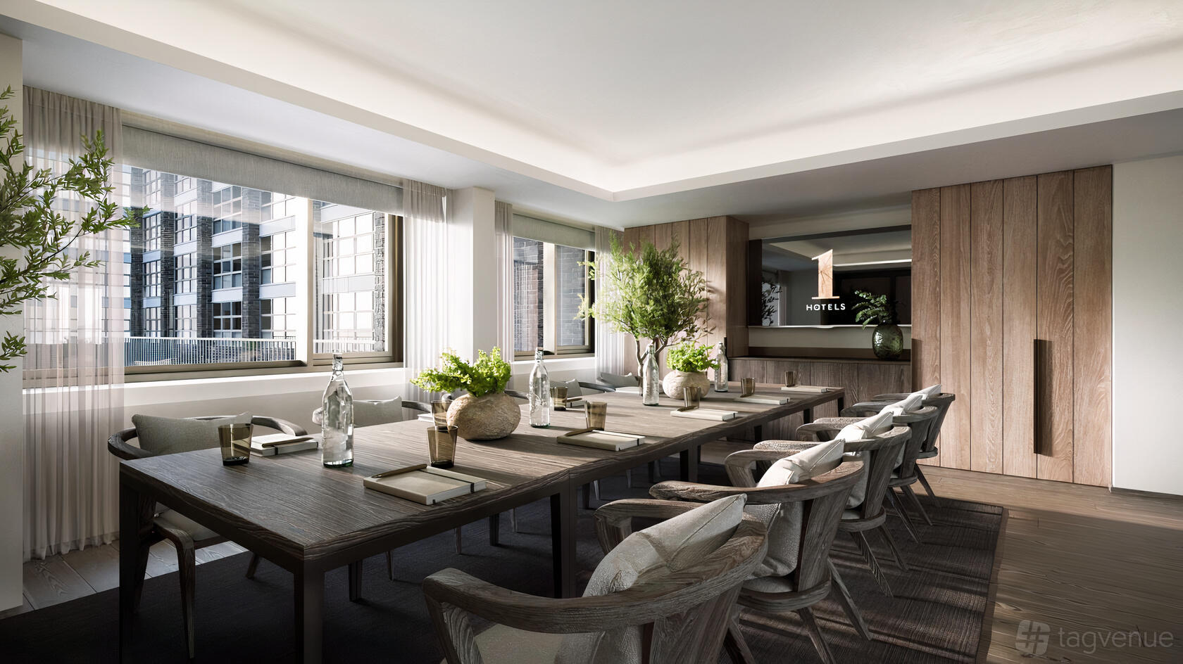 A meeting room with floor-to-ceiling windows, wood paneling, and a central boardroom table at 1 Hotel Mayfair.