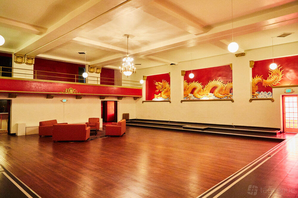 An event venue with red dragon murals, wood flooring, and a chandelier at Casa Vertigo’s Geisha Room.