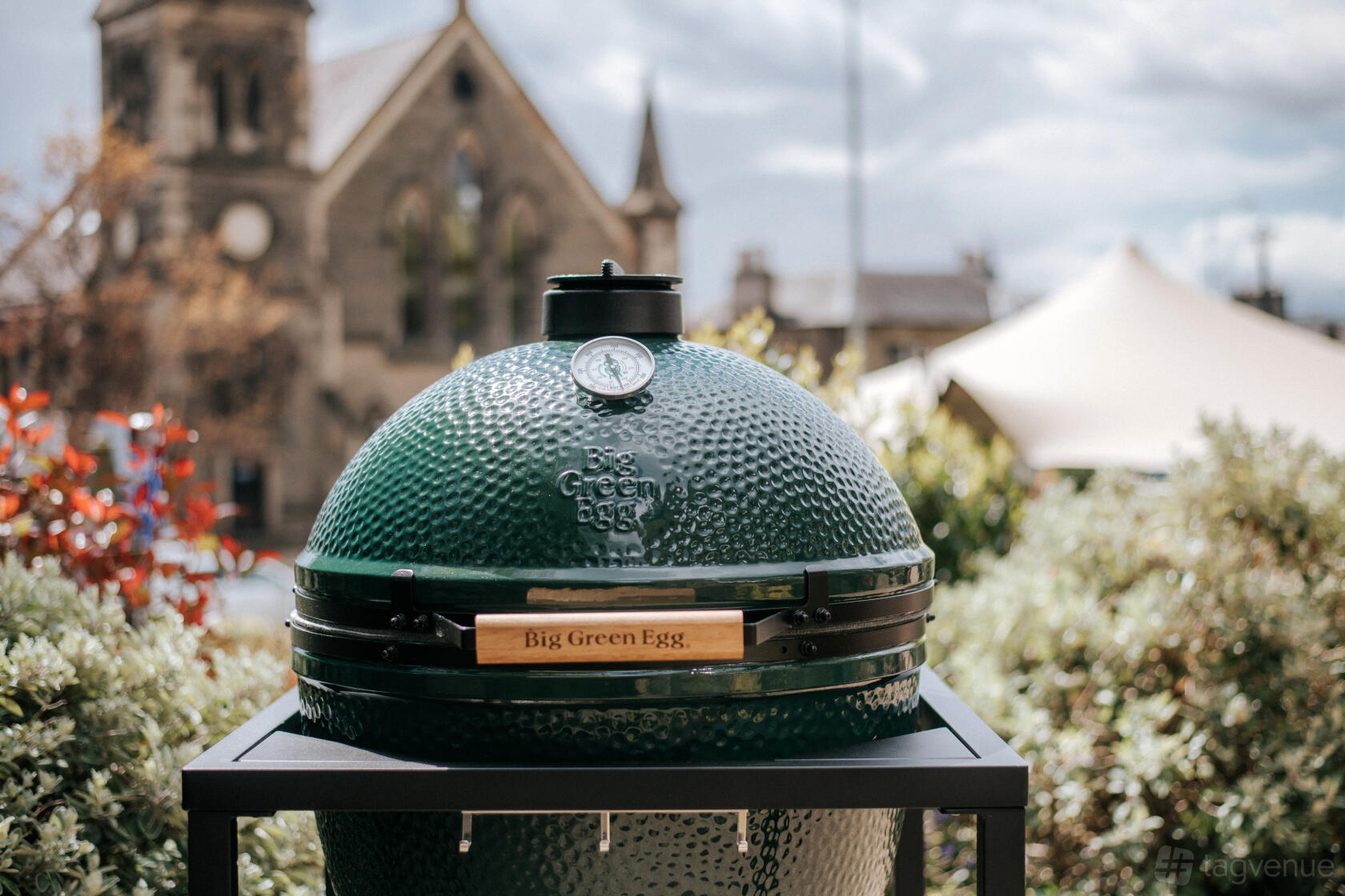 An outdoor hotel space with a Big Green Egg grill set among greenery at The Roseate Edinburgh.
