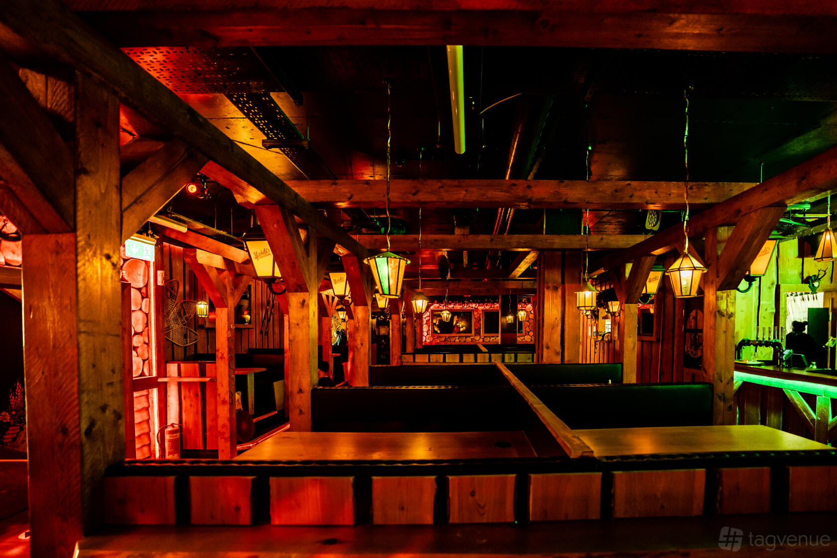 An event space in a bar with wooden beams, hanging lanterns, and booth seating at Barbara's Bier Haus Birmingham.