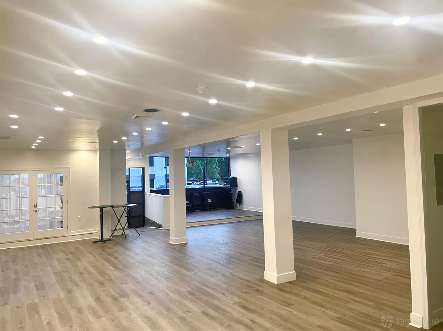 An event venue with wood flooring, recessed lighting, and expansive windows at The Greatness Center.