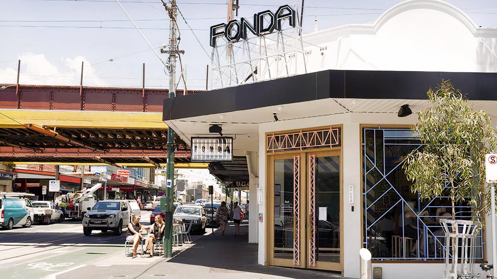 A restaurant with a geometric-patterned entrance and outdoor seating beneath a 'Fonda' sign at Fonda Mexican @ Hawthorn.