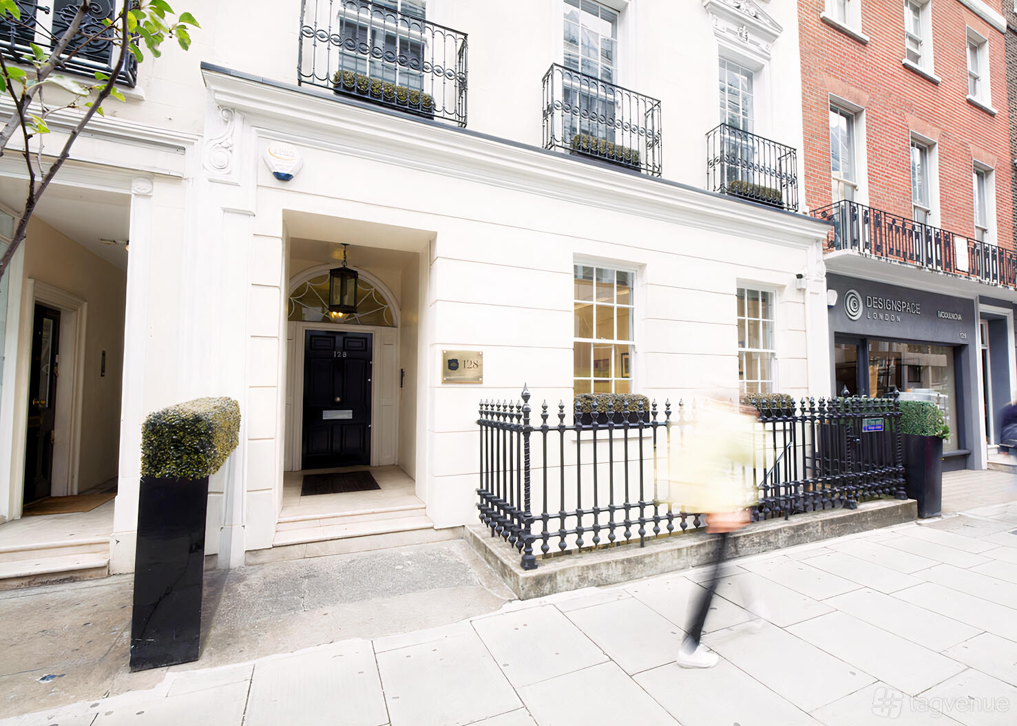 A meeting centre with a white townhouse exterior, black railings, and potted topiary at Portman Heritage.