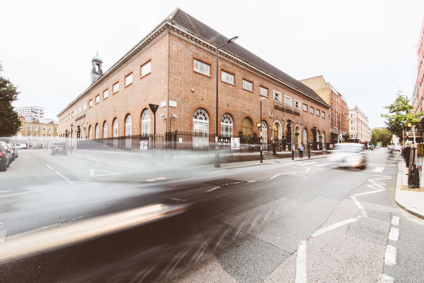 A versatile event space with large arched windows and a red brick facade at Seymour.