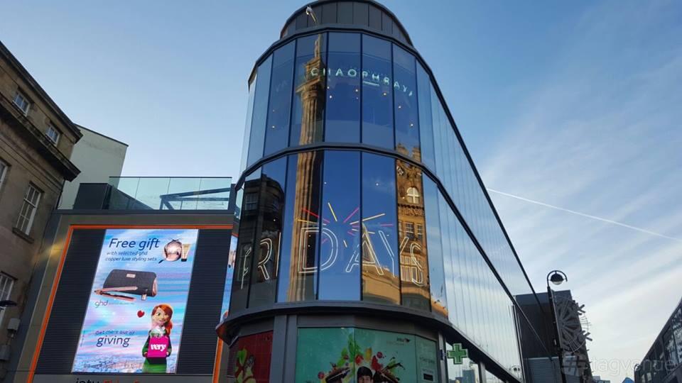 A restaurant with a glass-fronted exterior and city landmark reflections at Chaophraya Newcastle.