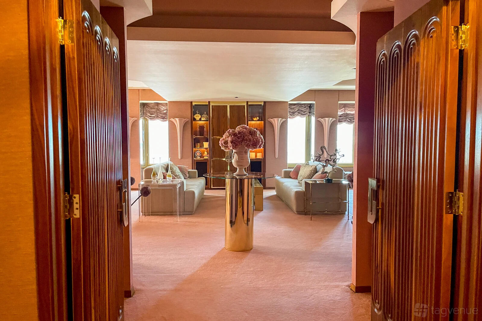 A hotel meeting room with plush seating, carpeted floors, and a central floral arrangement at El Cortez Hotel and Casino.