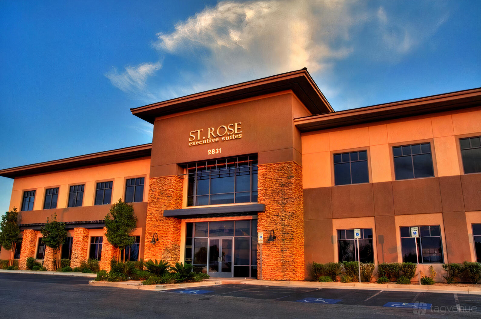 A meeting centre with a two-story entrance, stone accents, and tall windows at St Rose Executive Suites and Virtual Offices.
