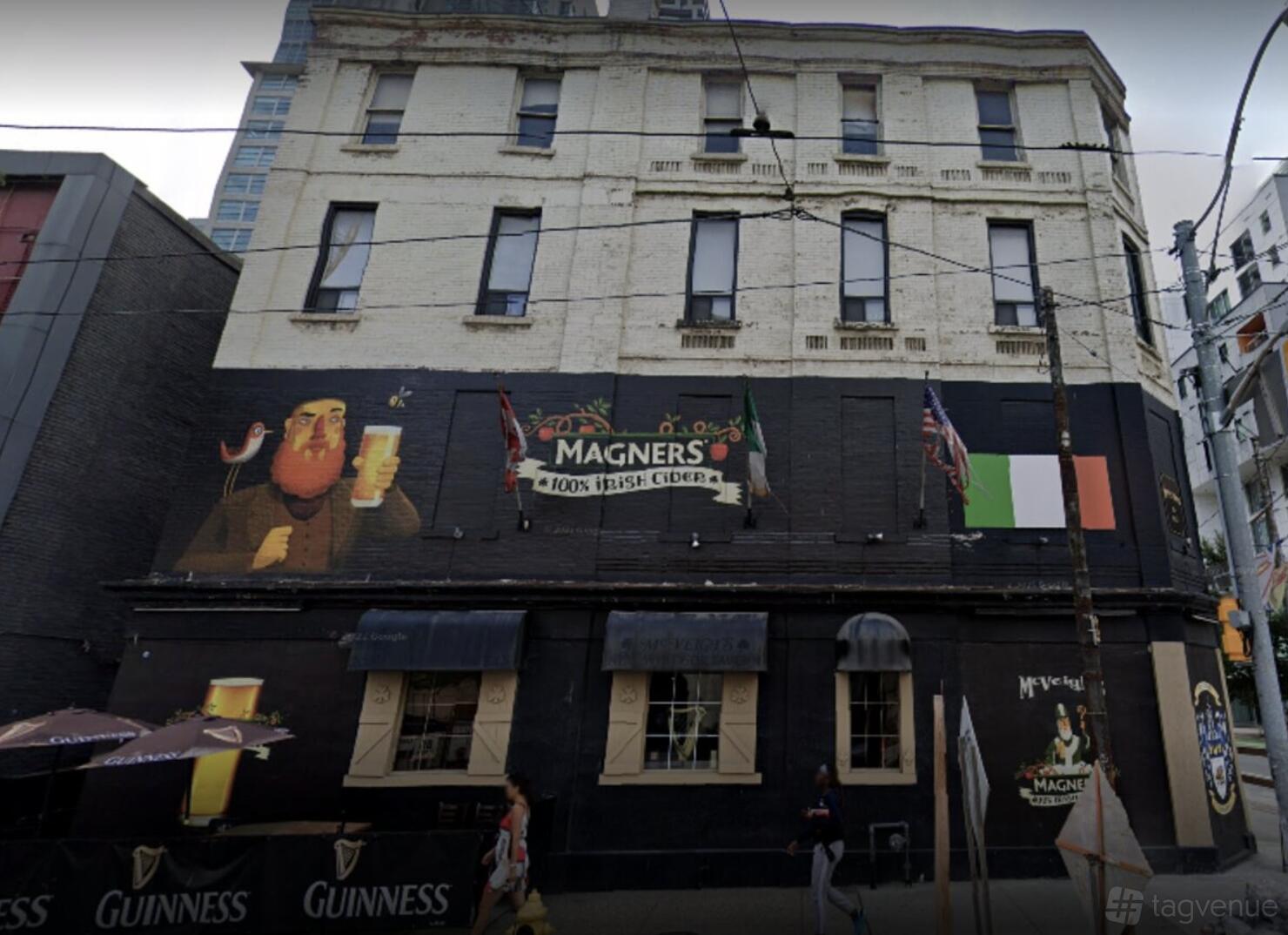 An Irish pub with a painted mural, flag decorations, and traditional signage at McVeigh's Irish Pub.
