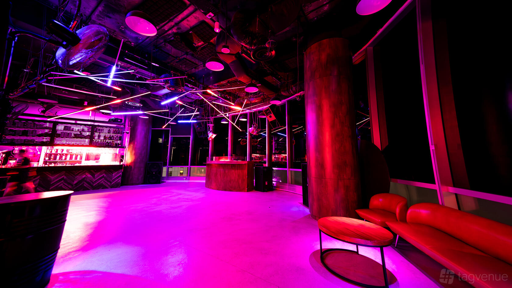 A nightclub with neon lighting, an illuminated bar counter, and lounge seating at TUFF CLUB.