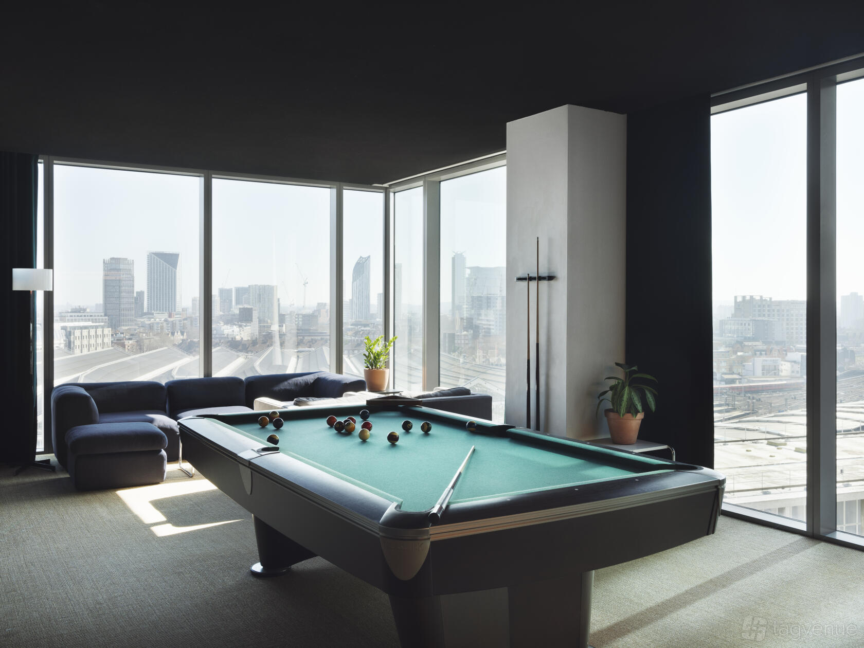 An event venue lounge with floor-to-ceiling windows, a pool table, and city views at 10 York Road.
