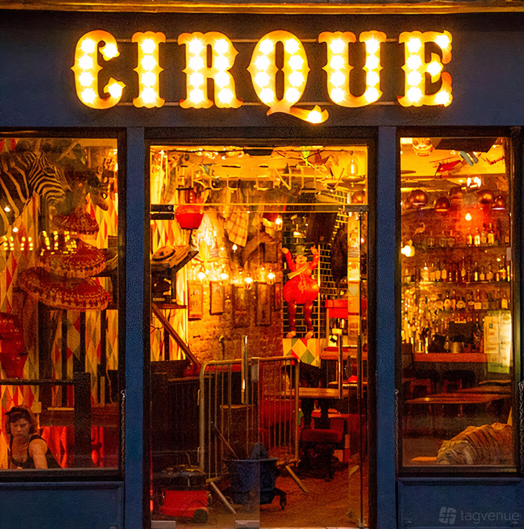 A versatile event space with circus-themed decor, colorful lights, and eclectic wall art at Cirque.