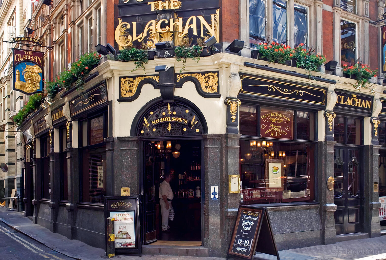 A historic pub with ornate black and gold exterior signage and large street-facing windows at Clachan.
