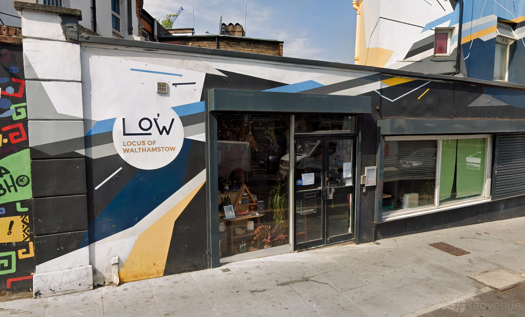 A meeting centre with geometric mural facade, glass entrance, and street-facing windows at The Twelfth House.
