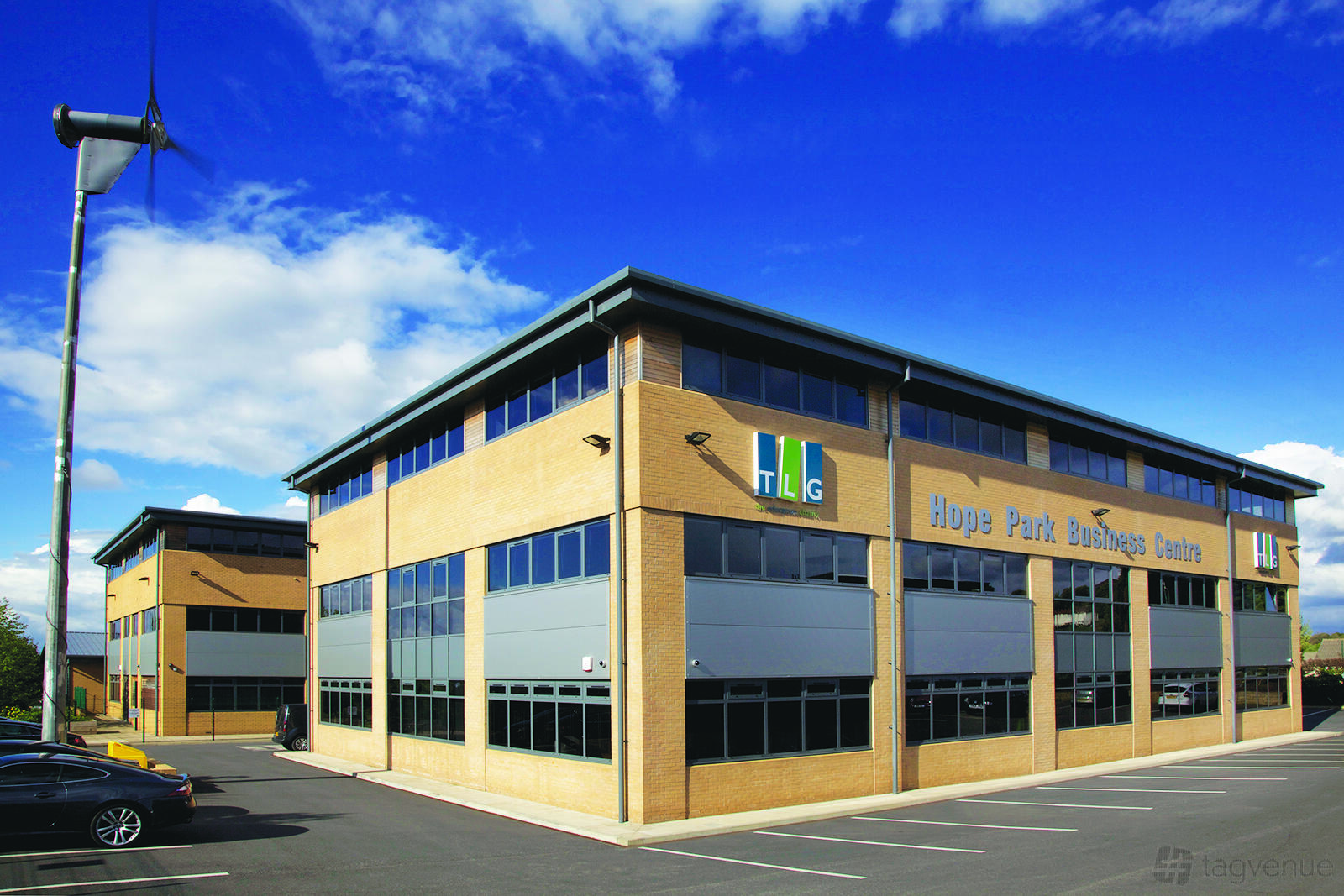 A meeting centre with a brick exterior, large windows, and onsite parking at Hope Park Workspaces, City Gateway.