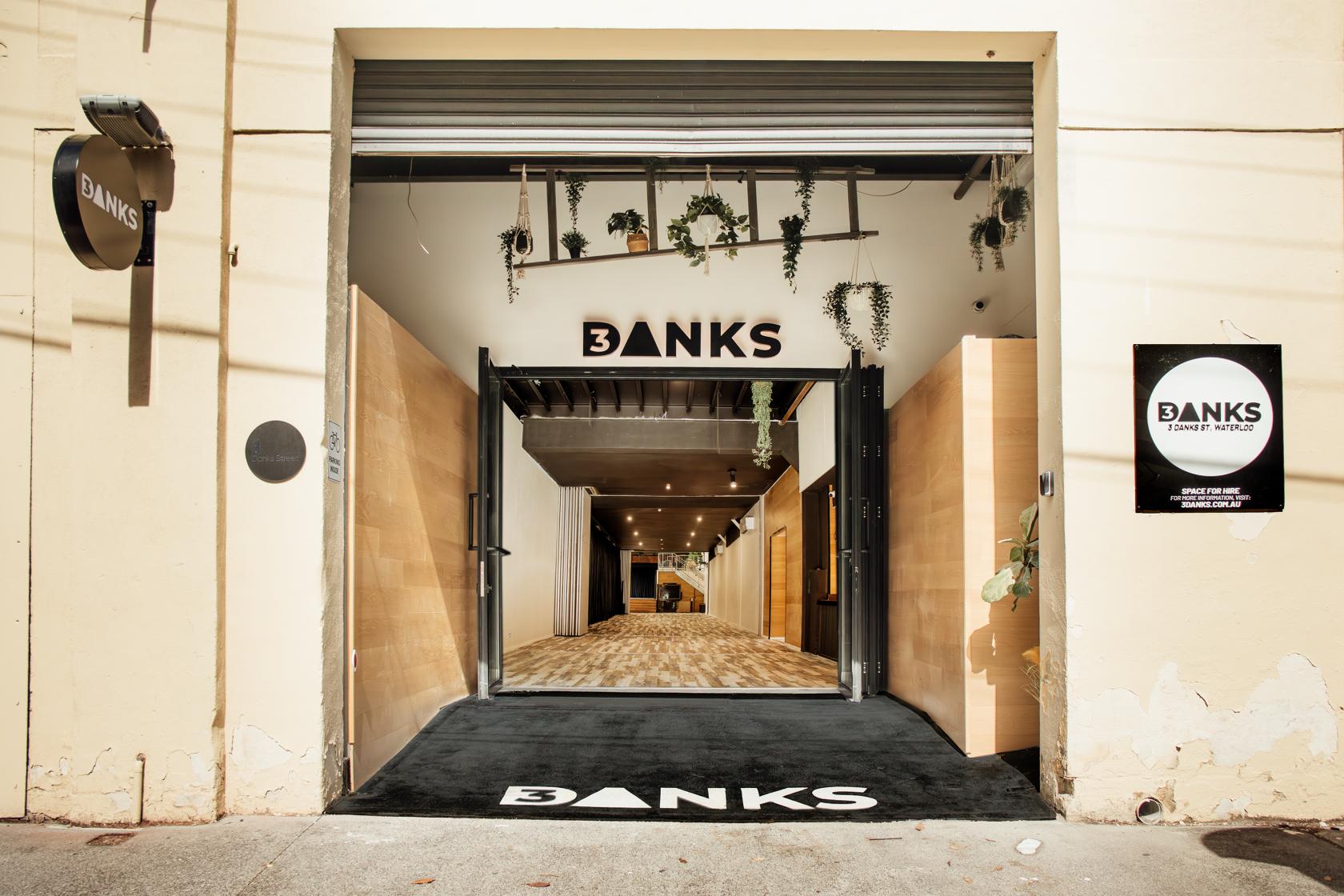 A versatile event space with open entryway, hanging greenery, and wood flooring at 3Danks Waterloo.