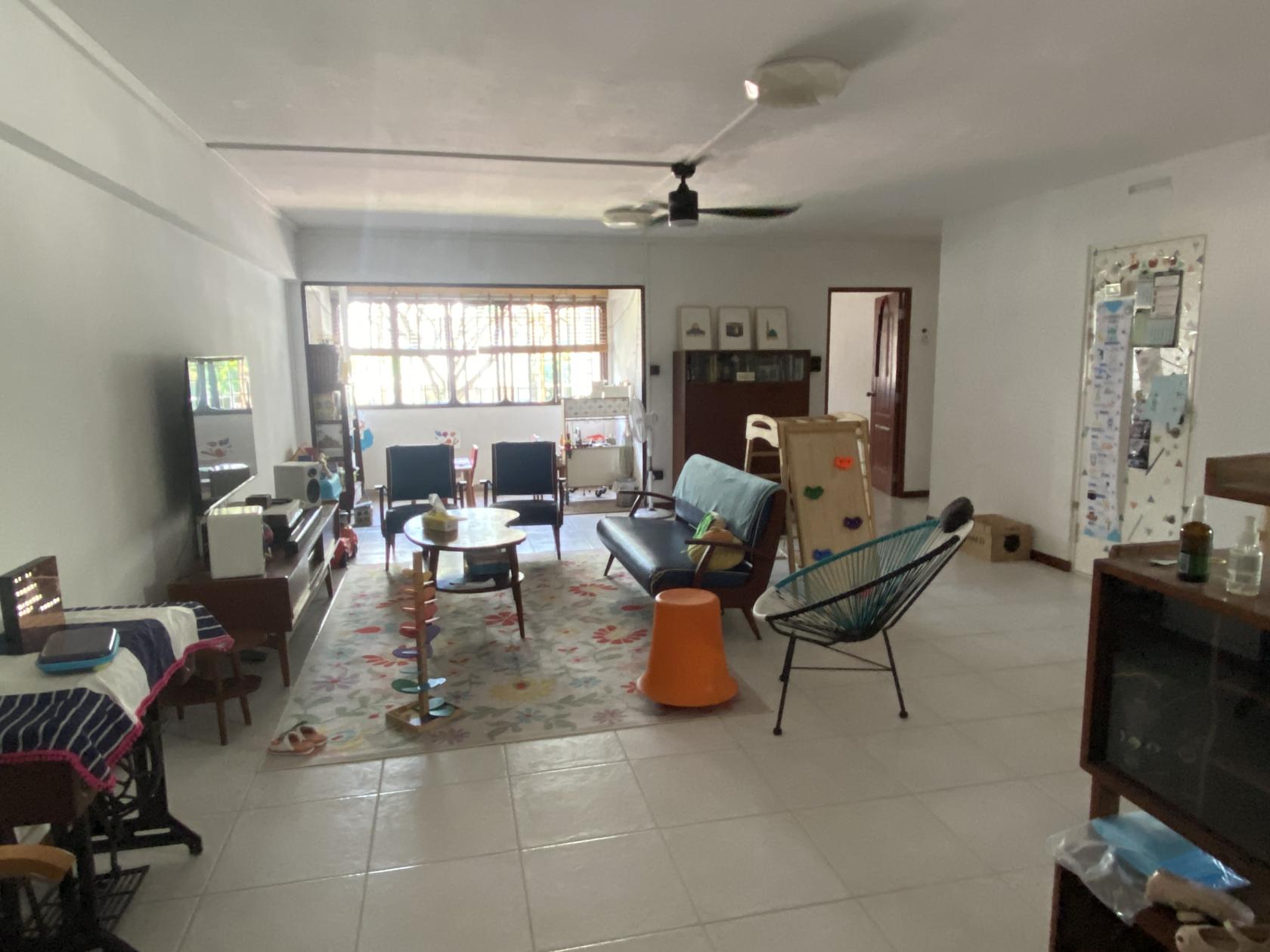 An apartment with mid-century modern furniture, patterned rug, and large windows at Mid Century Modern (MCM) inspired.