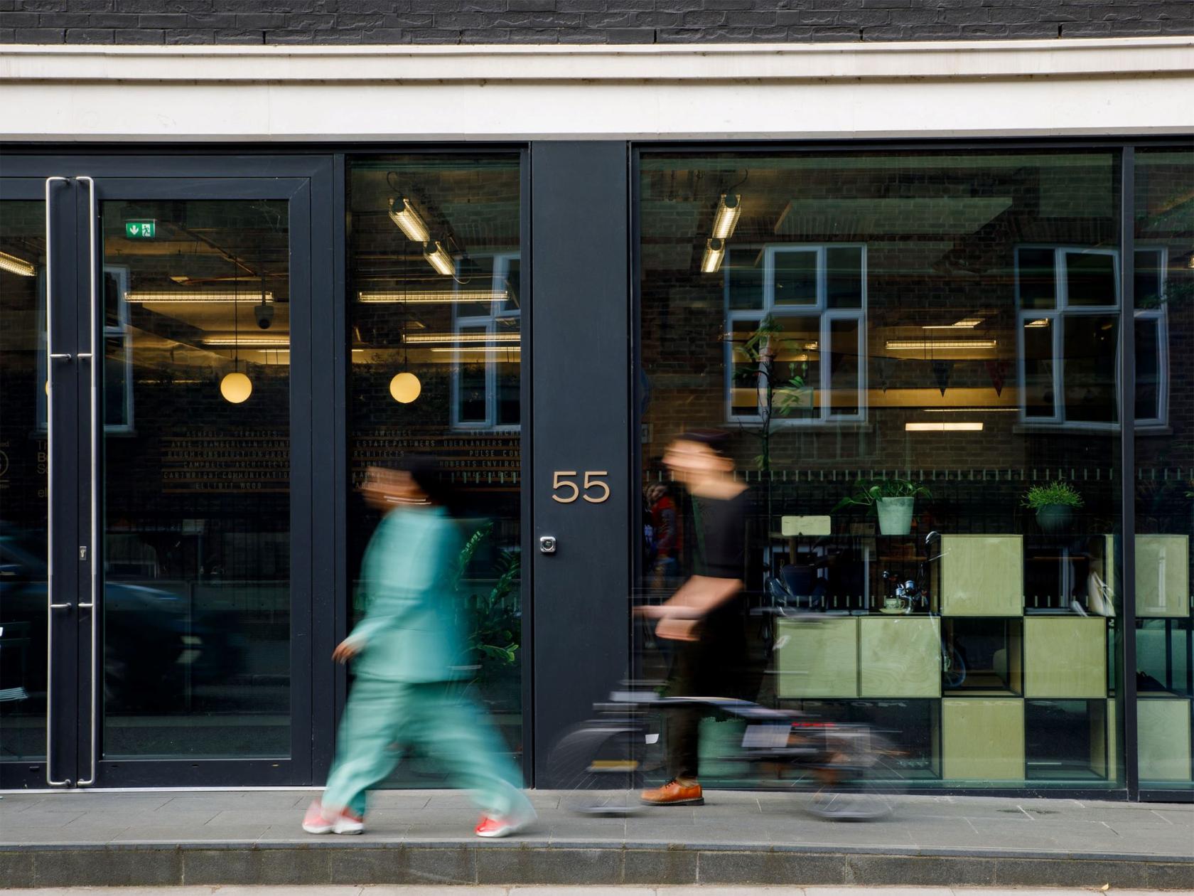 A meeting centre with floor-to-ceiling windows, double glass doors, and modern lighting at The Society Building - Fitzrovia.