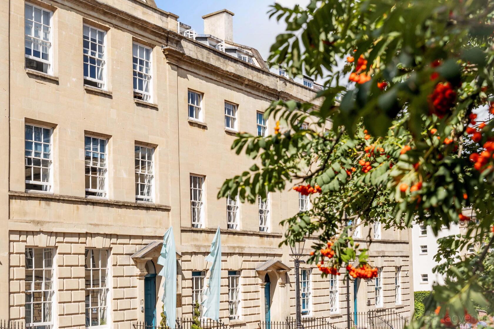 A historic coworking space with tall sash windows and stone facade at Square Works.