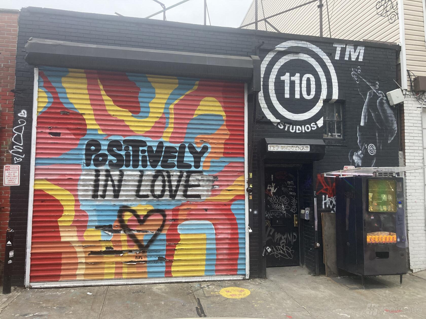 A film and photo studio with a colorful graffiti mural and large roll-up door at 110 Studios.