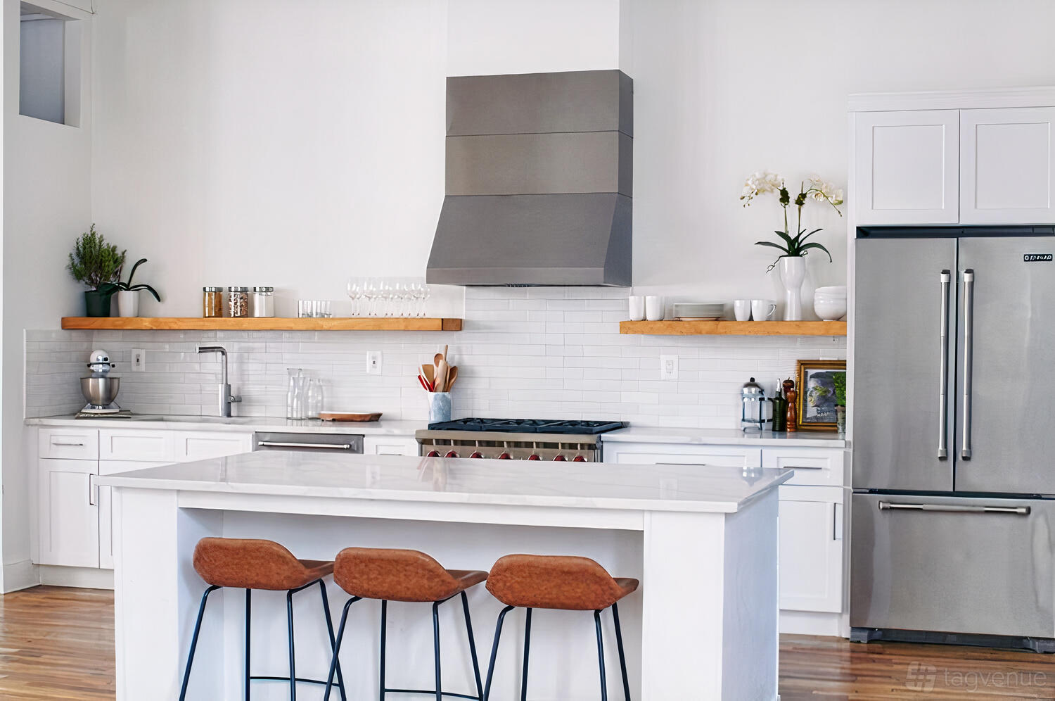 A photo studio kitchen with a marble island, open wooden shelves, and stainless steel appliances at Space 28.