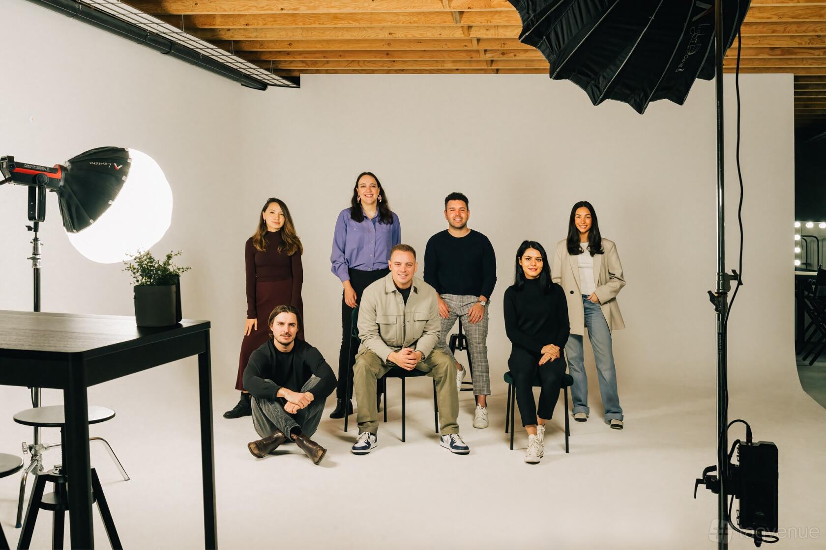 A photo studio with professional lighting, seamless white backdrop, and exposed wood ceiling at Yarraville Studio Hire.