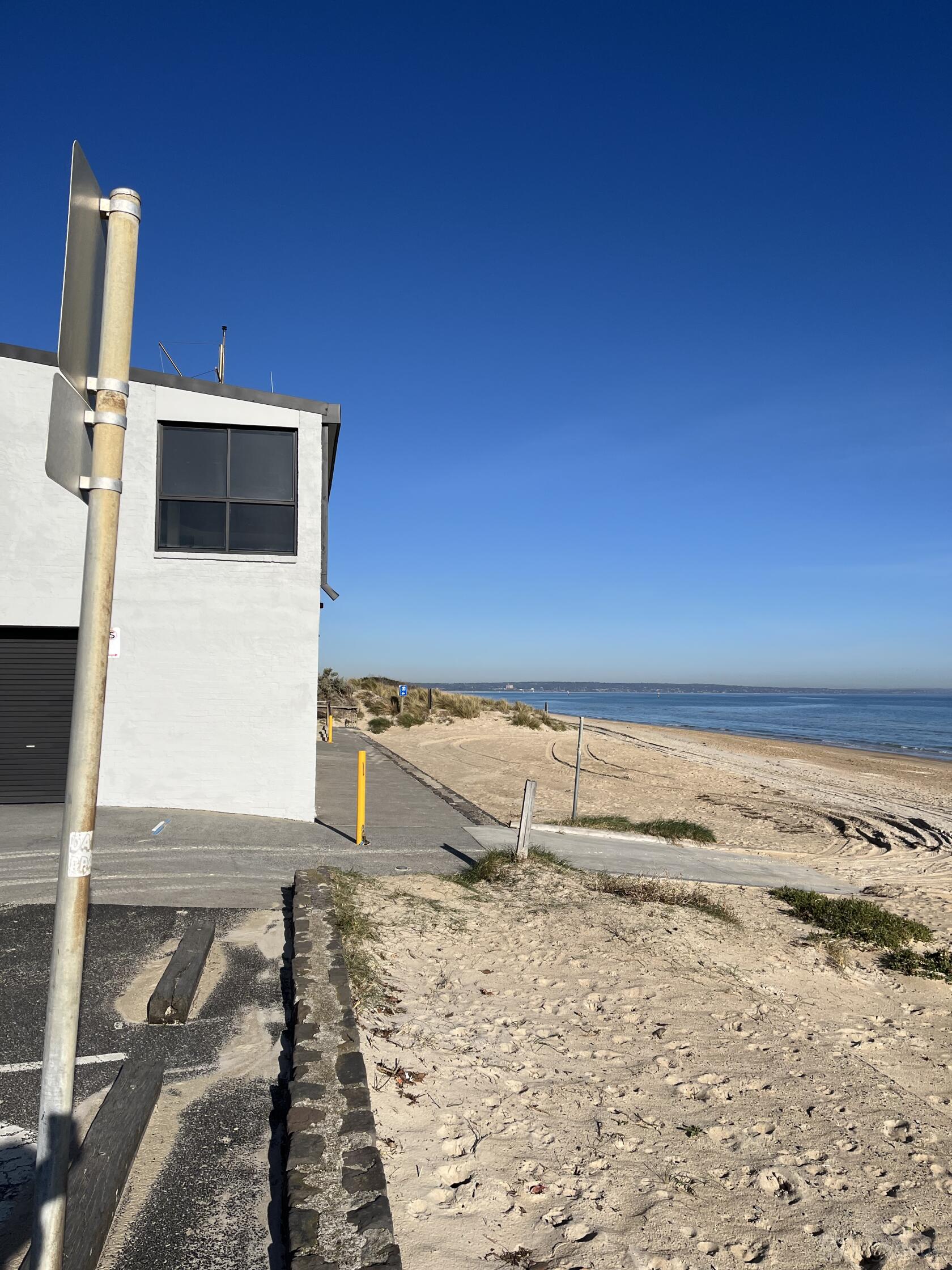A versatile event space with large windows overlooking the sandy beach and ocean at Chelsea Yacht Club.