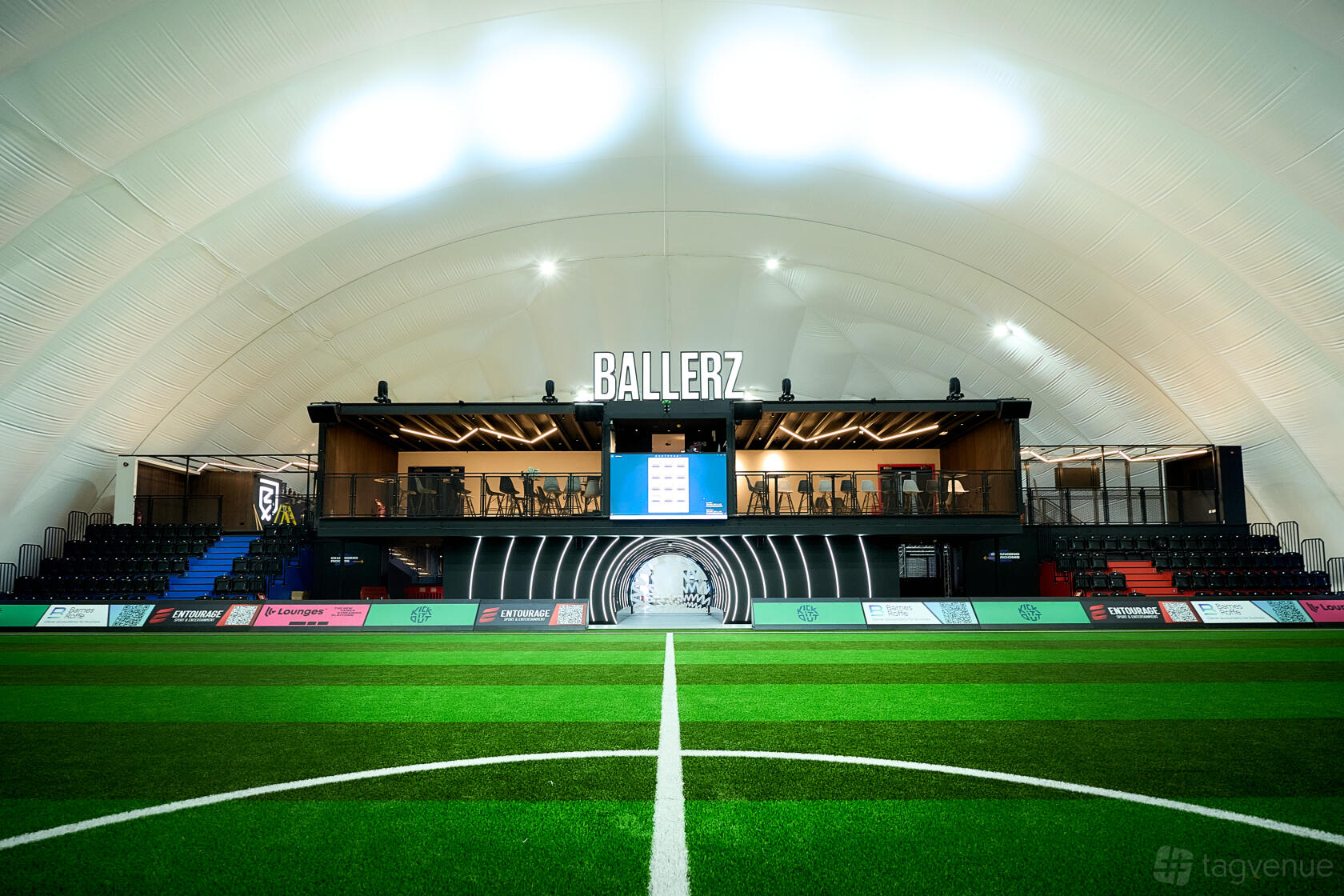 An event venue with an indoor football pitch, artificial turf, and elevated viewing gallery at Ballerz.