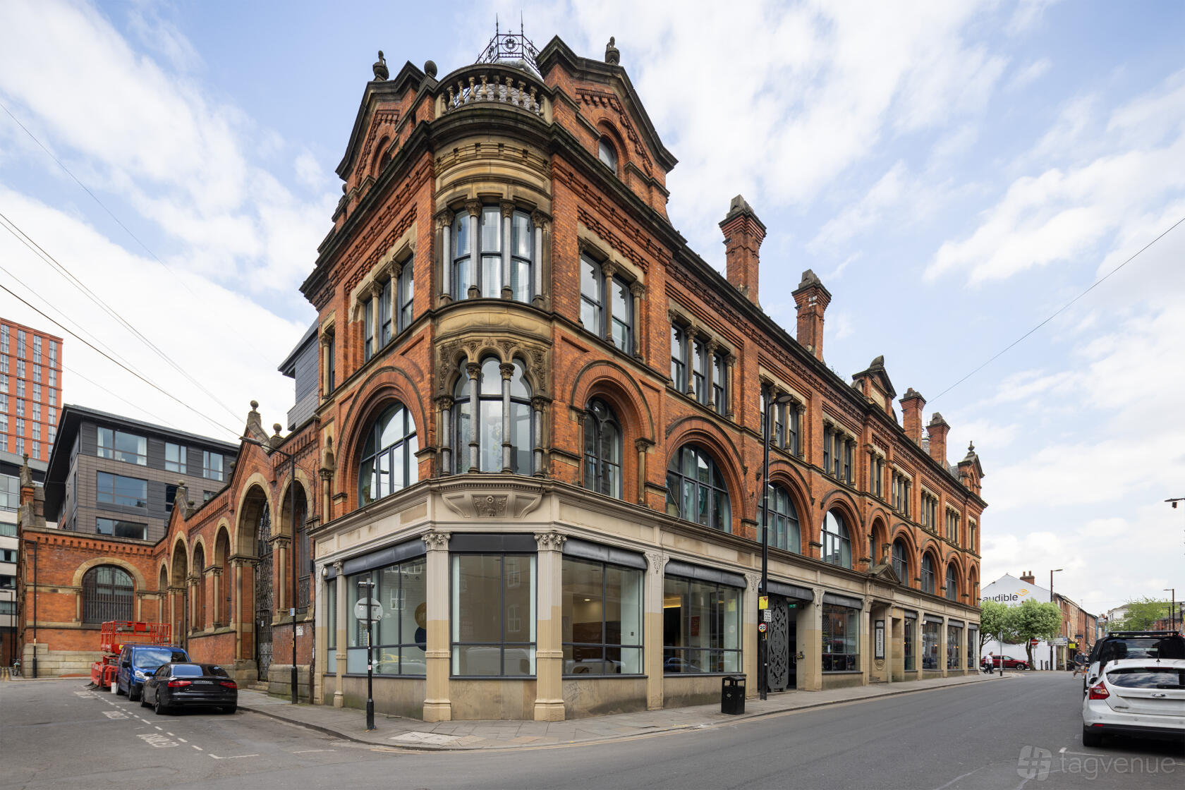 A red brick versatile event space with large arched windows and corner entrance at esea contemporary.