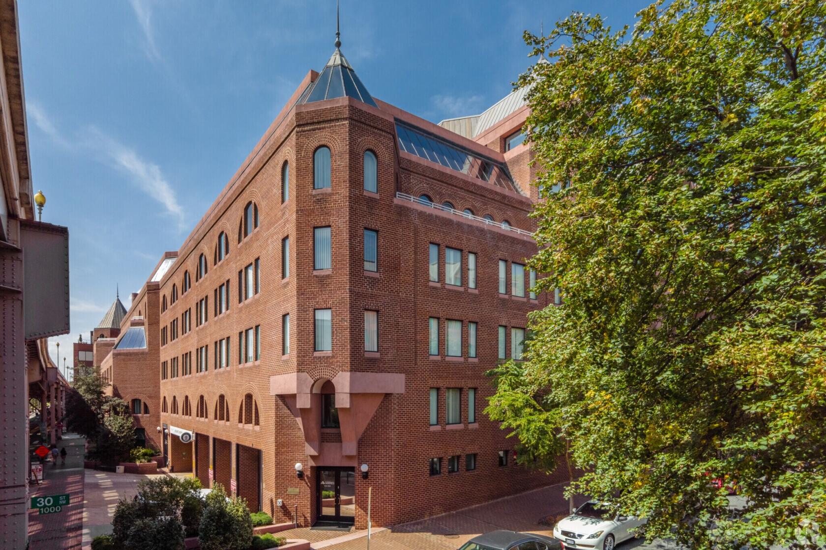 A brick meeting centre with arched windows and a pointed roof at AdvantEdge Workspaces.