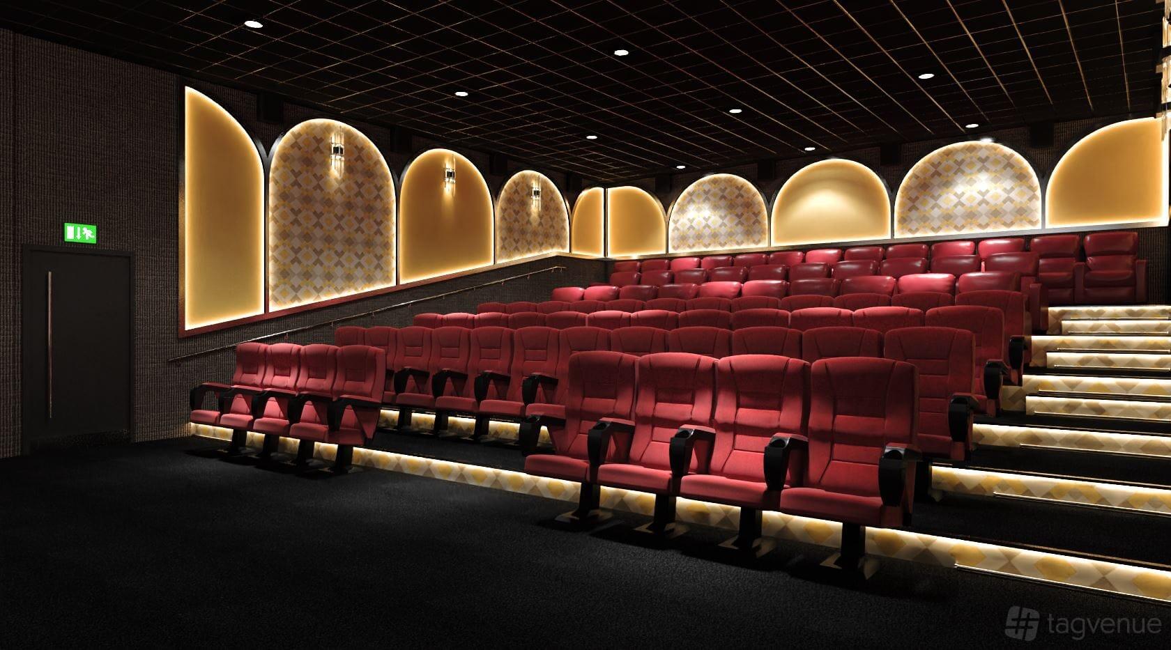 A cinema screening room with red tiered seats, illuminated aisles, and patterned wall panels at Roxy Movies Middlesbrough.