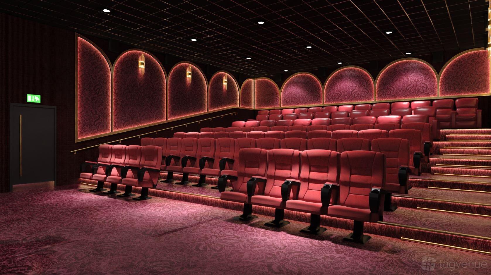 A screening room with tiered red velvet seats, patterned wallpaper, and warm wall lighting at Roxy Movies Middlesbrough.