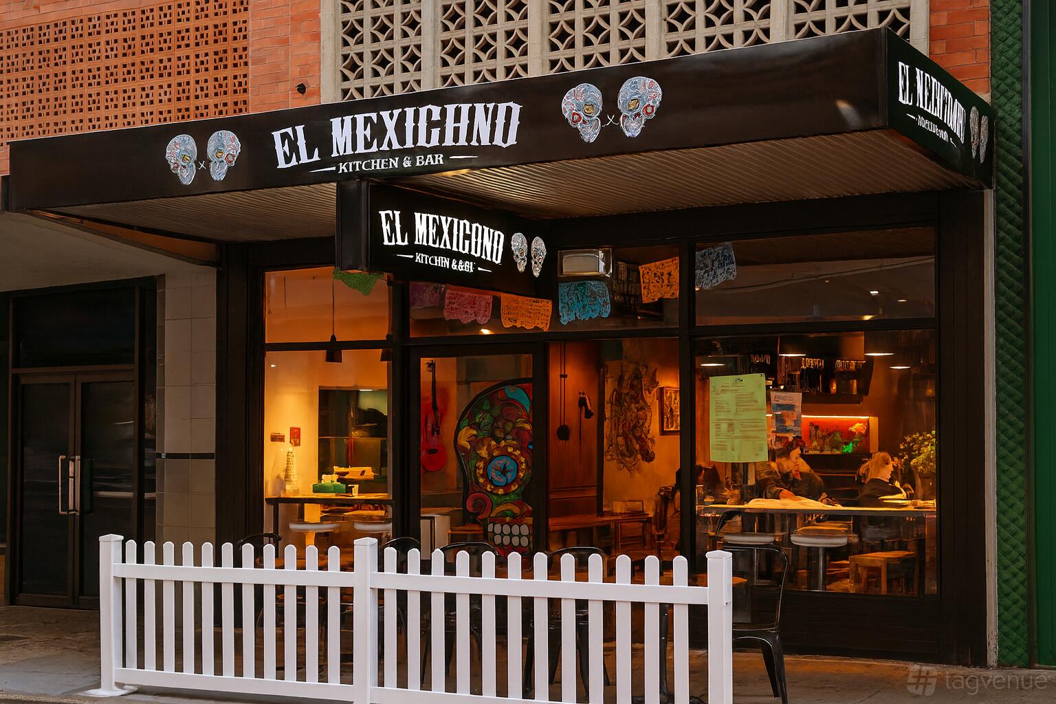 A versatile event space with a glass storefront, outdoor awning, and white picket fence at EL Mexicano Hyde Park.